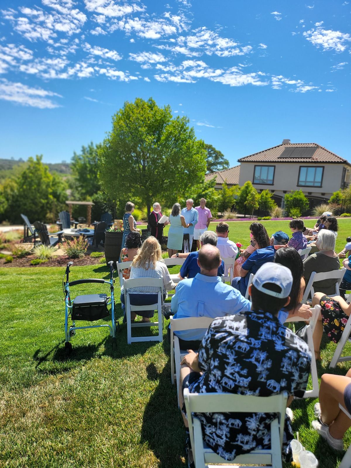 Guests seated on the lawn for an outdoor ceremony