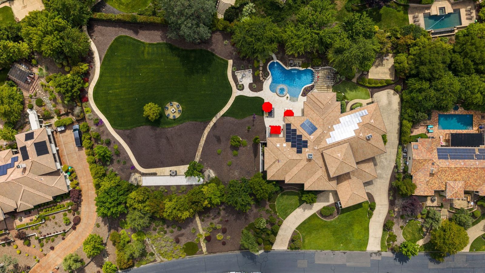 Vista del Prato from directly above, showing the lawn, firepit, bocce court, pool, pavilion, sport court, residence and circular drive