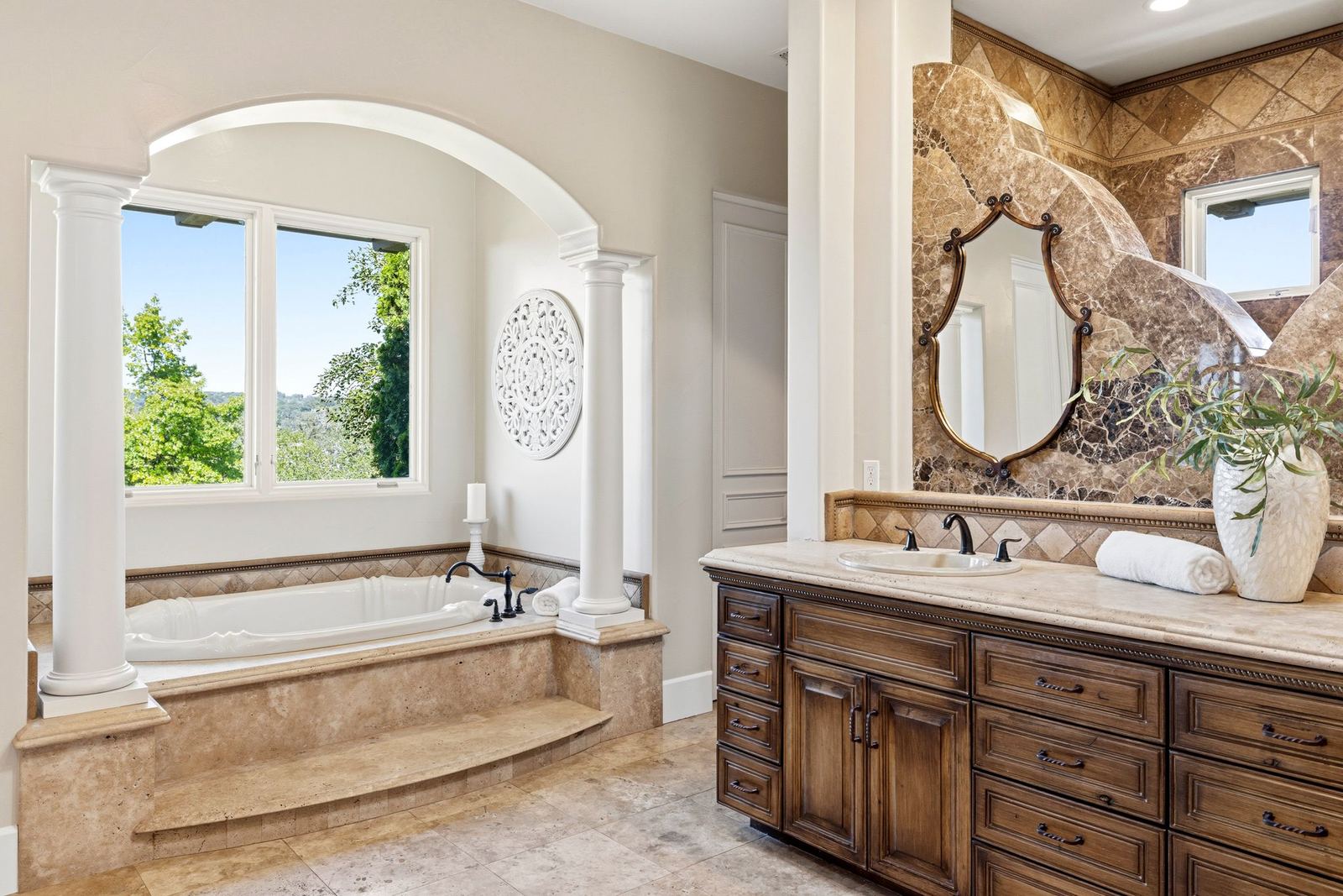 Soaking tub under an arched window in the spa bath